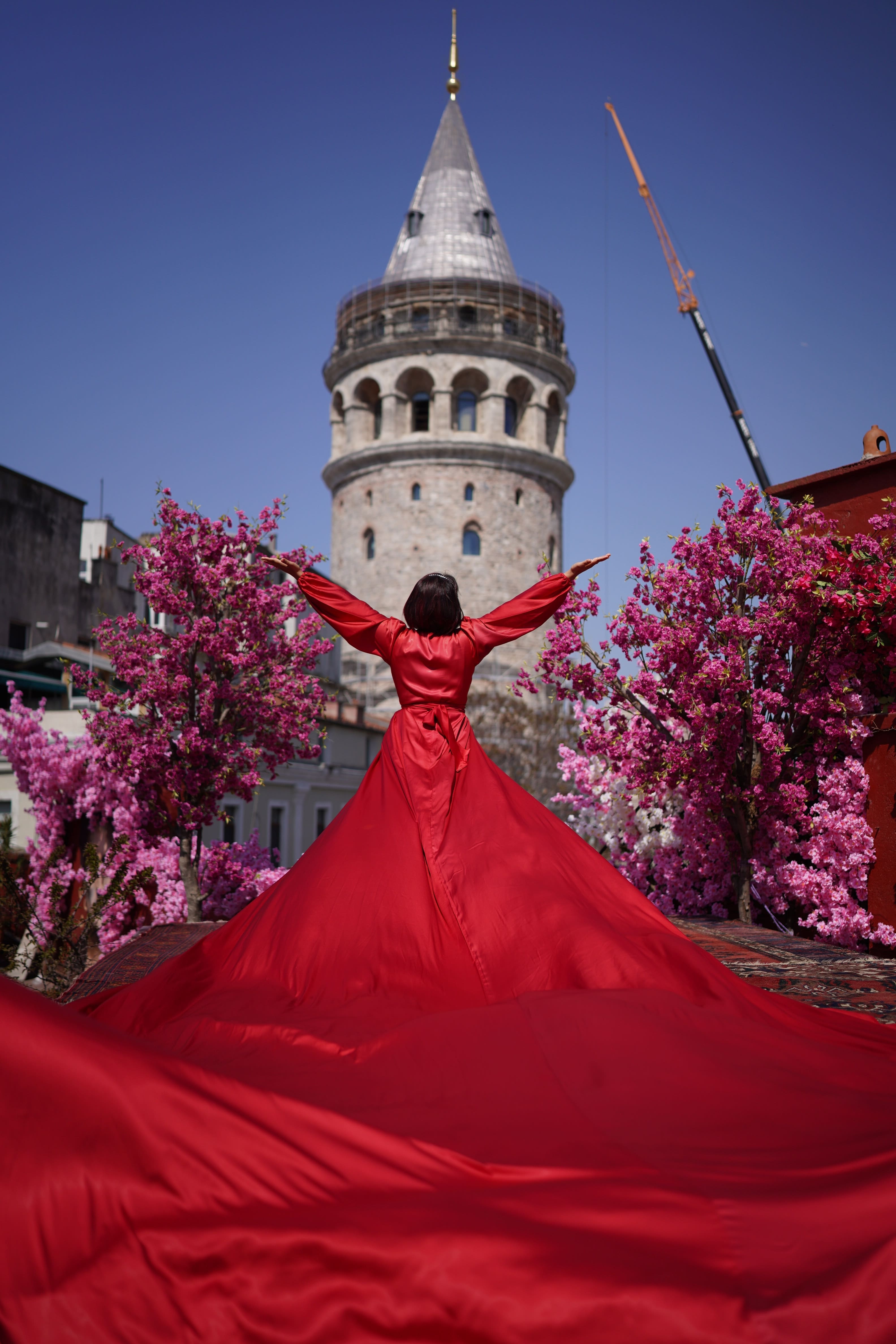 Galata Tower Istanbul with red dress and spring blossoms